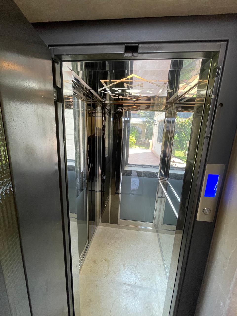 Front view into the completed mirrored residential elevator cabin
